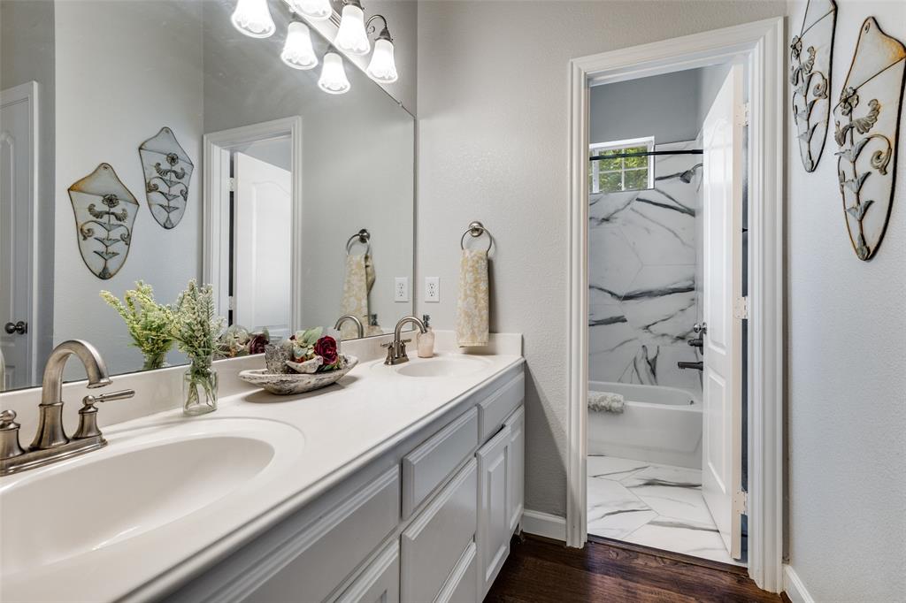 5809 Rathbone Drive Parker, TX 75002 - Photo 24 of 36 a bathroom with a sink a mirror and a shower