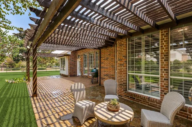 a patio with glass top table and chairs