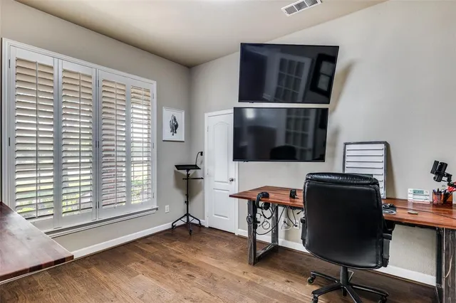 a view of a workspace with furniture and a window