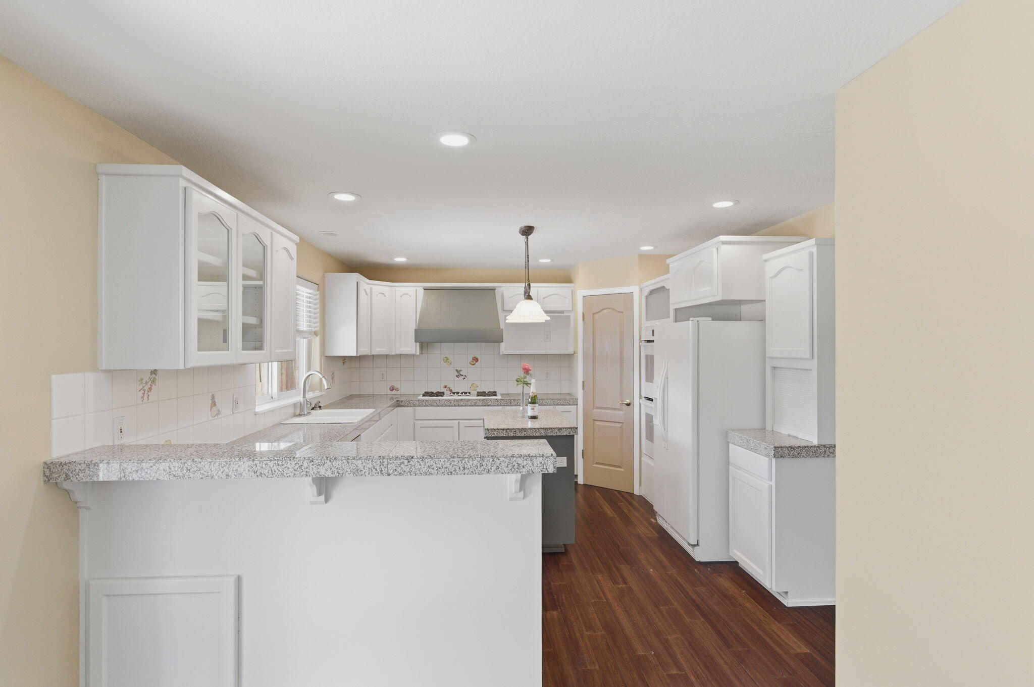 196 Nadine Lane Central Point, OR 97502 - Photo 13 of 54 a kitchen with stainless steel appliances granite countertop a refrigerator a sink dishwasher and white cabinets with wooden floor