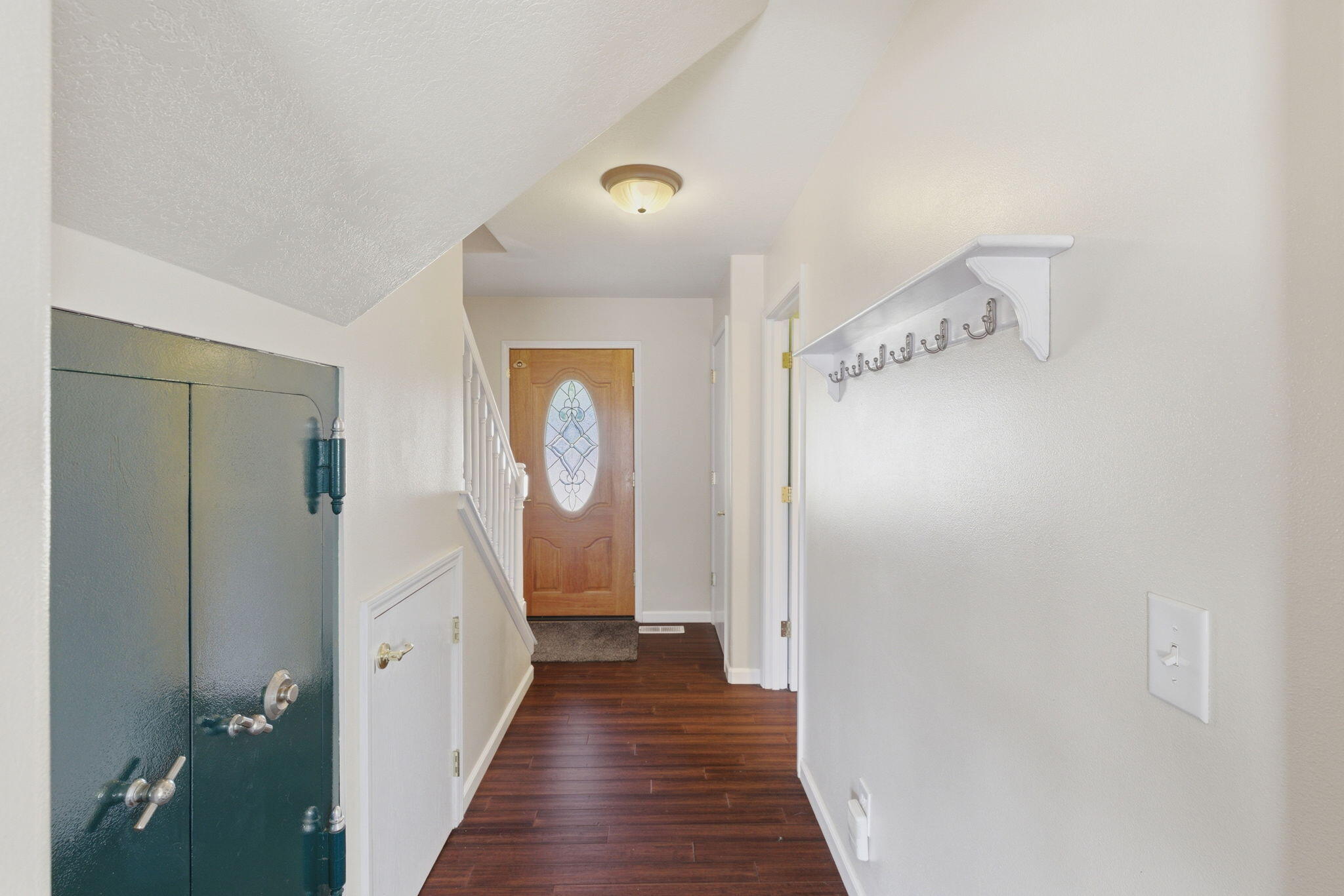 196 Nadine Lane Central Point, OR 97502 - Photo 17 of 54 a view of a hallway with wooden floor and staircase