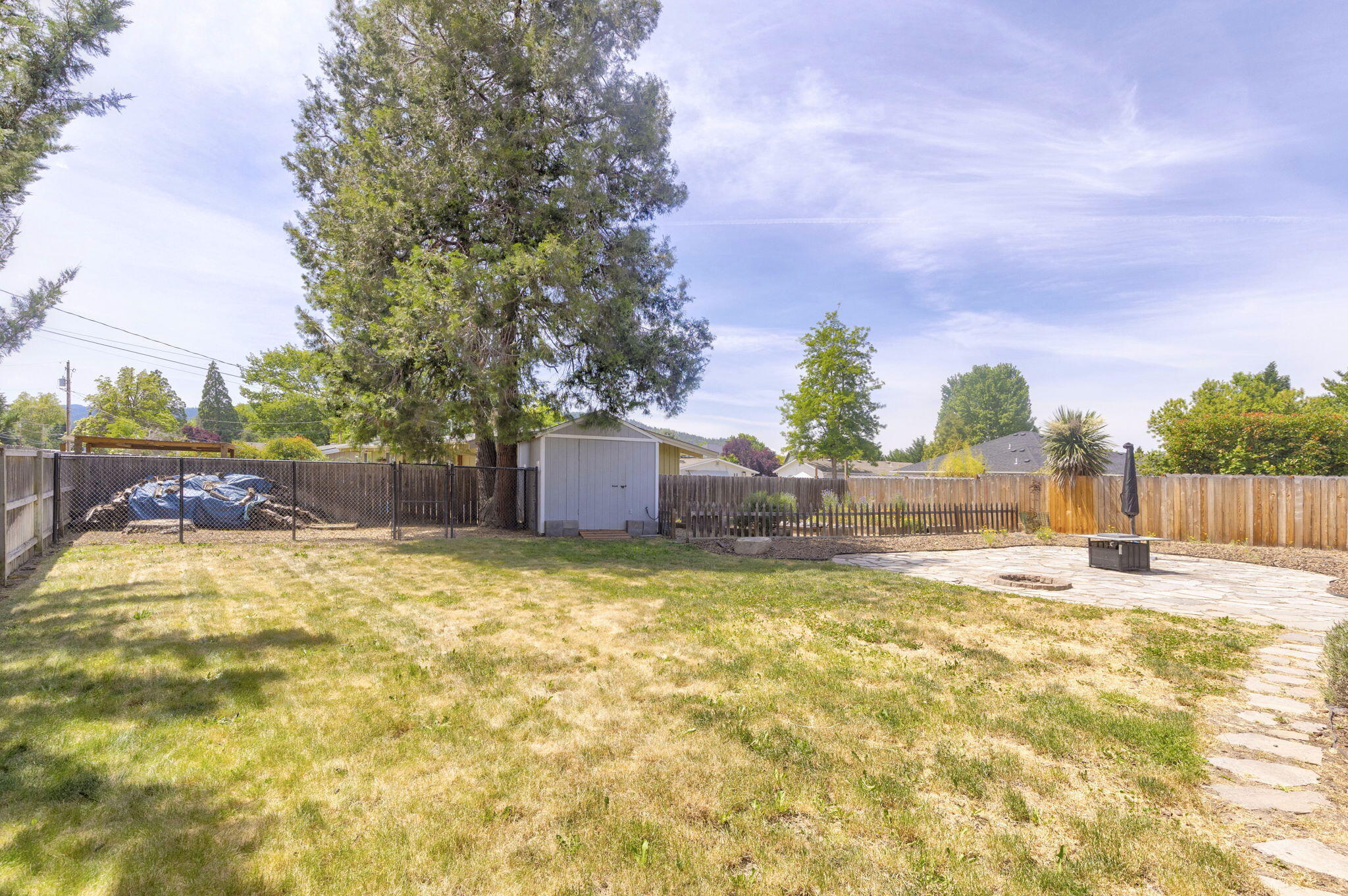 196 Nadine Lane Central Point, OR 97502 - Photo 39 of 54 a backyard of a house with table and chairs