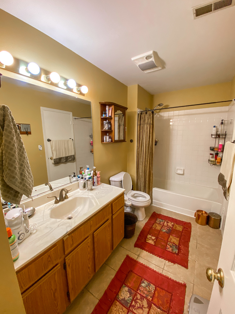 233 Dickens Trail Elgin, IL 60120 - Photo 16 of 18 a bathroom with a sink double vanity granite tub shower and a mirror