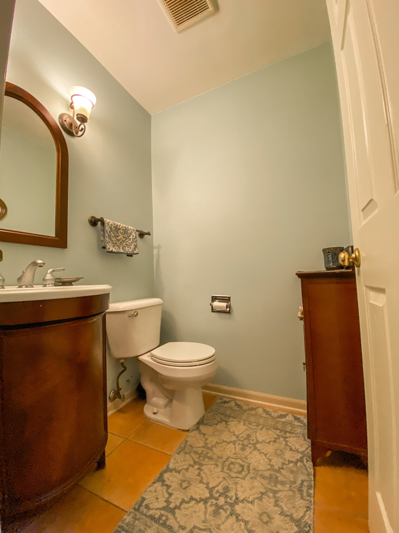 233 Dickens Trail Elgin, IL 60120 - Photo 17 of 18 a bathroom with a sink a toilet and mirror