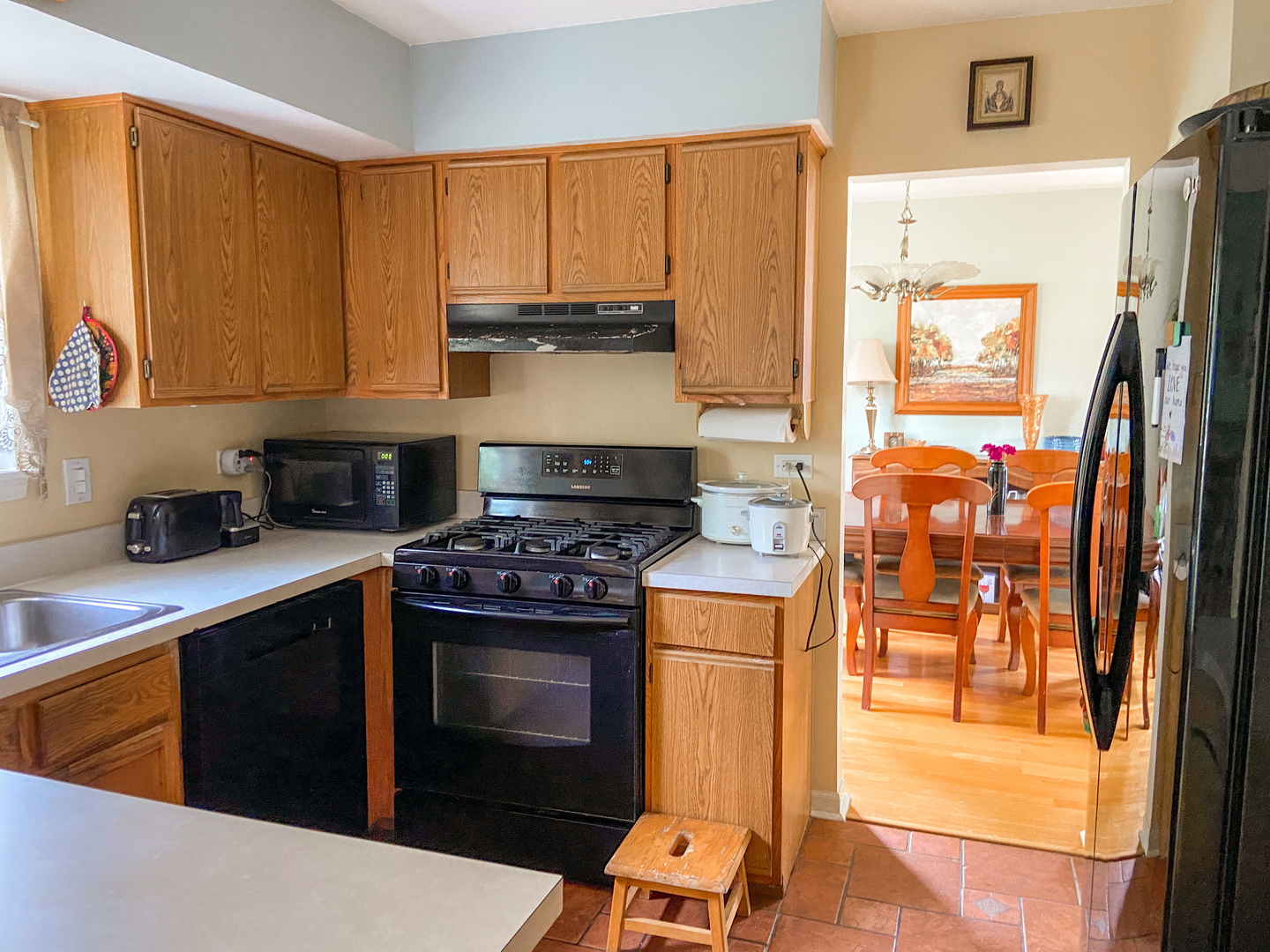 233 Dickens Trail Elgin, IL 60120 - Photo 5 of 18 a kitchen with stainless steel appliances granite countertop a stove a sink and a refrigerator