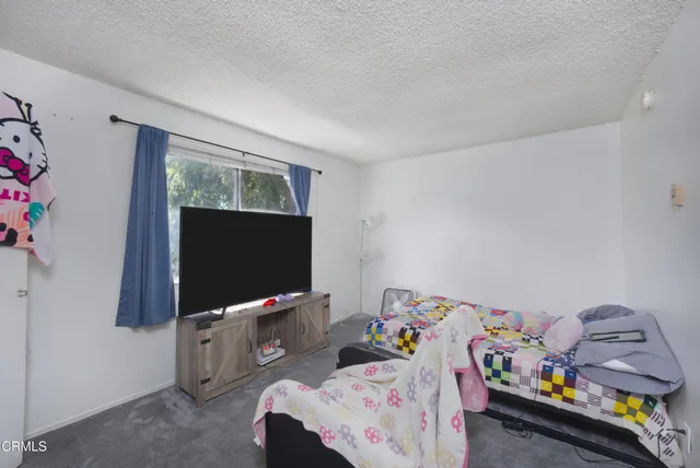 a bedroom with toys and a flat screen tv
