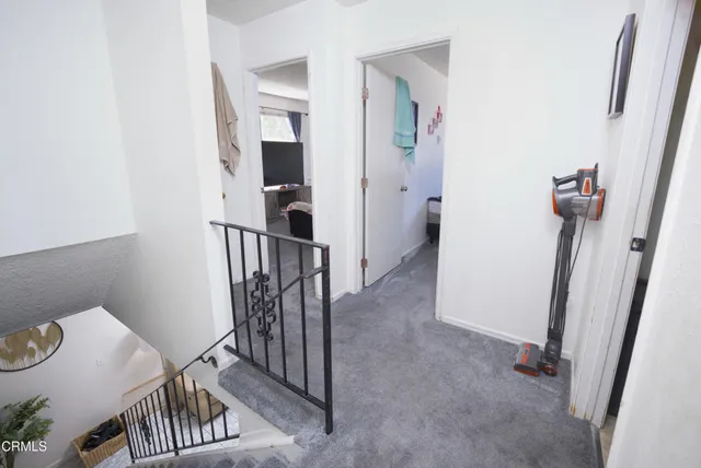 a view of a livingroom with wooden floor and stairs