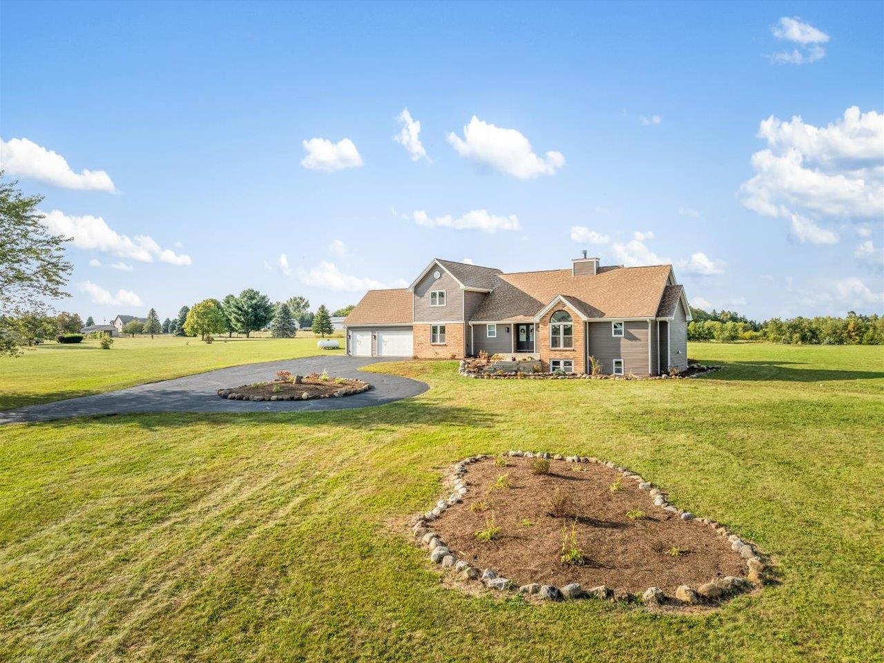 9281 Auburn Road Winnebago, IL 61088 - Photo 61 of 64 a front view of a house with a big yard