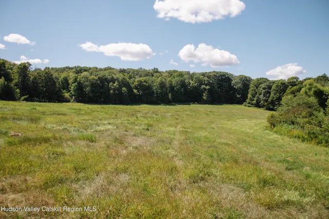 a view of house with backyard and outdoor seating