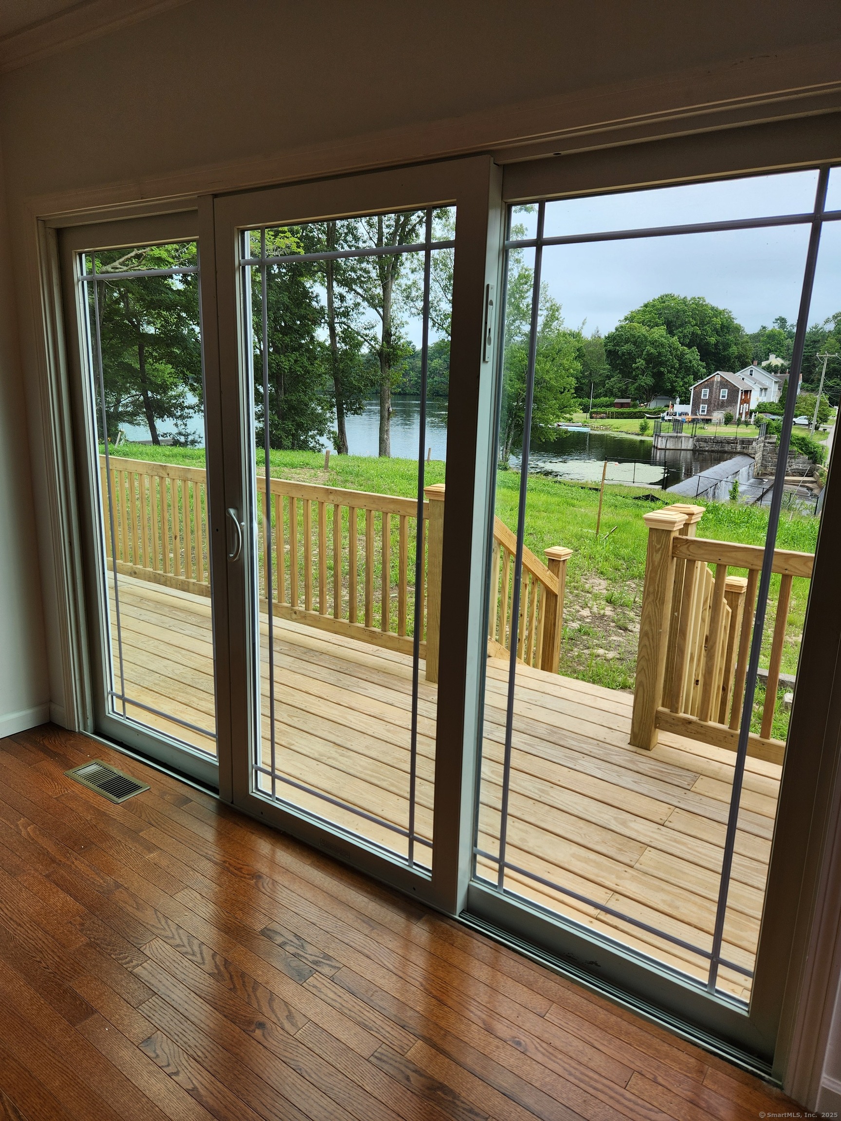 154 Falls Road East Haddam, CT 06469 - Photo 11 of 39 a view of a deck with a floor to ceiling window and wooden floor