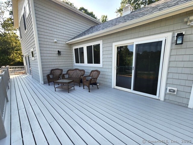 154 Falls Road East Haddam, CT 06469 - Photo 28 of 39 a view of a patio with table and chairs with wooden floor and fence
