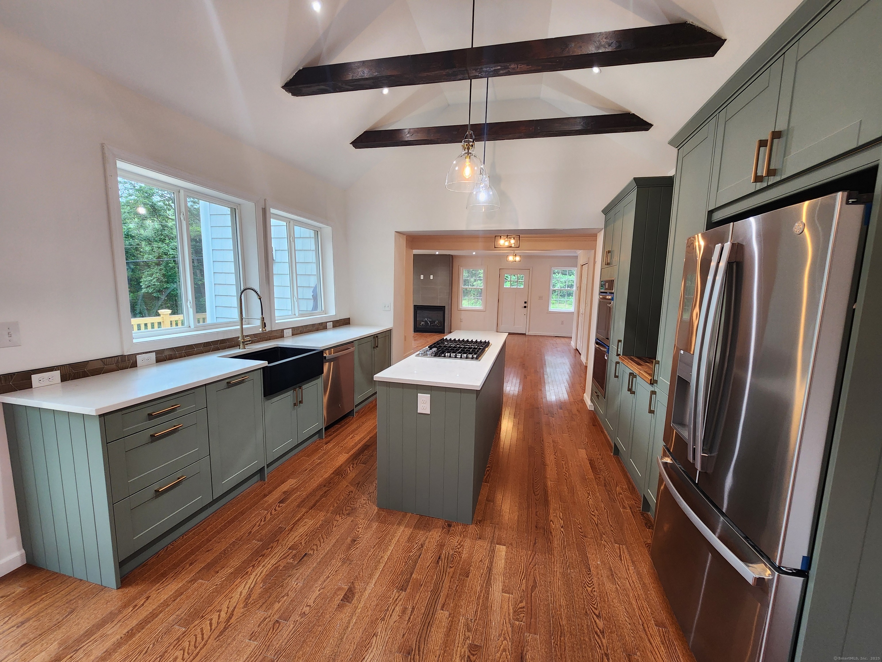 154 Falls Road East Haddam, CT 06469 - Photo 37 of 39 a kitchen with stainless steel appliances a refrigerator a sink dishwasher a stove and white countertops with wooden floor