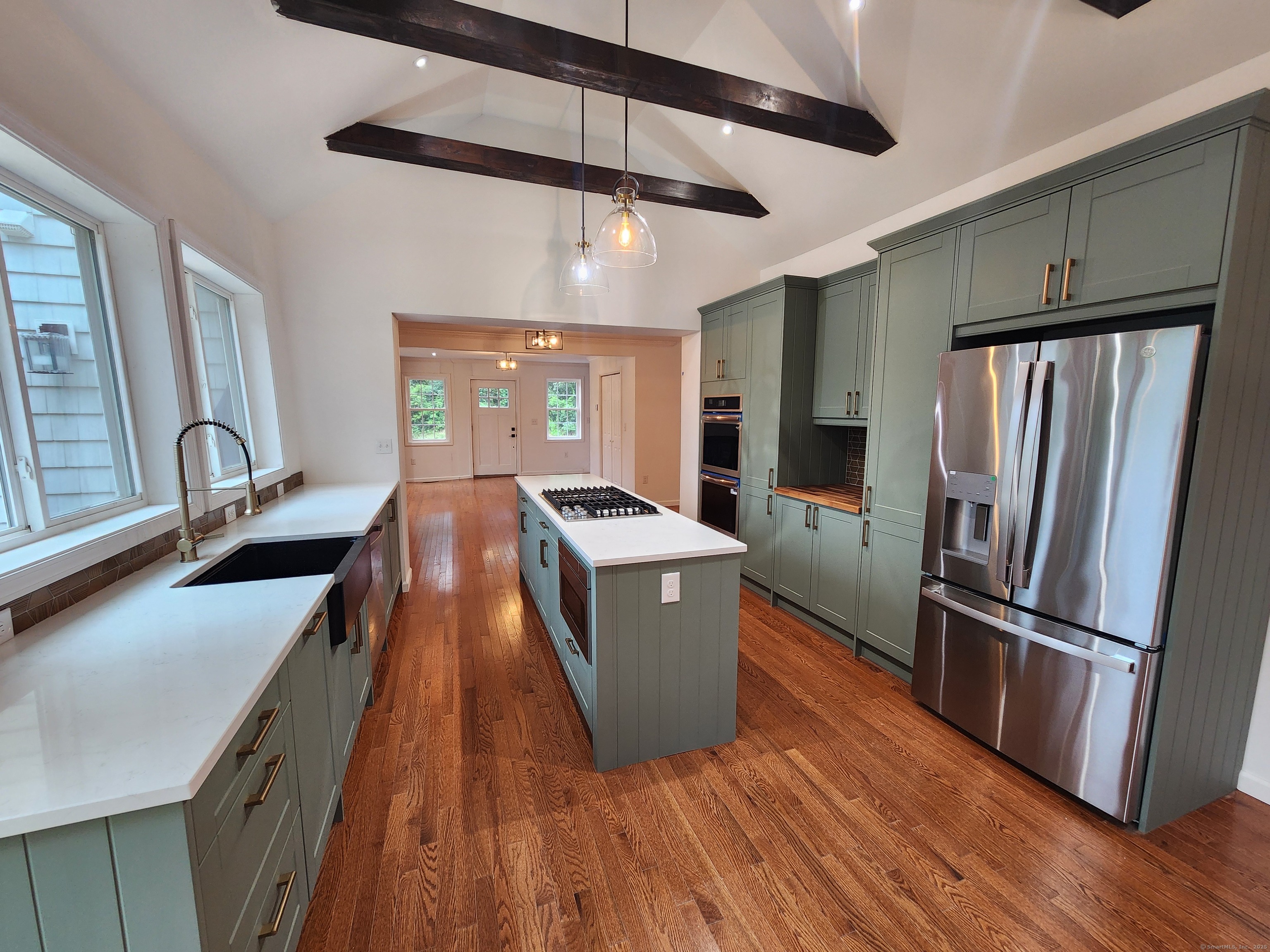 154 Falls Road East Haddam, CT 06469 - Photo 4 of 39 a kitchen with kitchen island a counter top space a sink a refrigerator and wooden floor