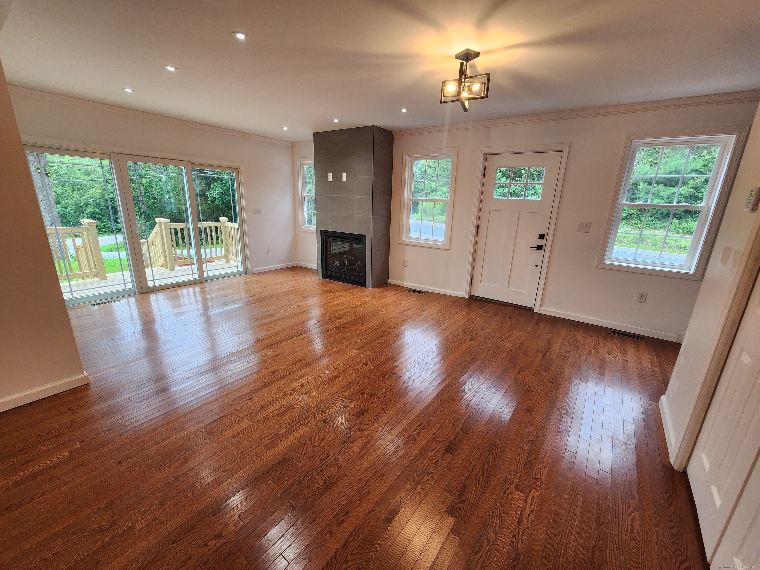 154 Falls Road East Haddam, CT 06469 - Photo 9 of 39 a view of an empty room with wooden floor and a window