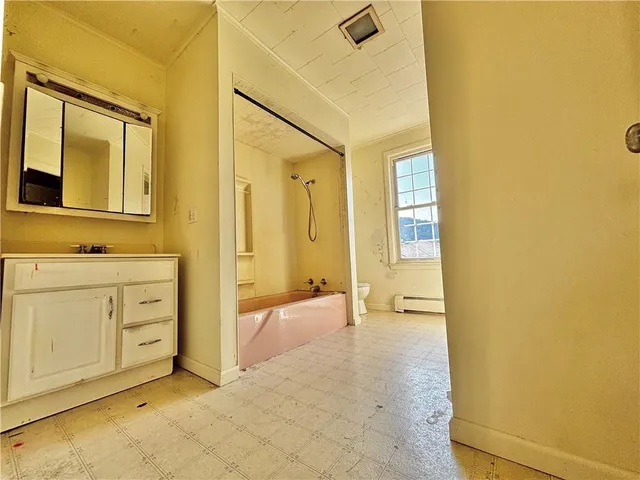 a view of a bathroom with a tub sink and mirror