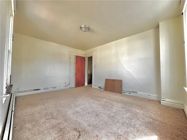 an empty room with windows and entrance