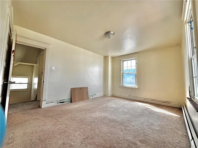 a view of a livingroom with furniture and a window