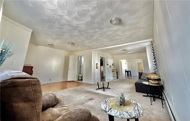 a living room with furniture and a mirror