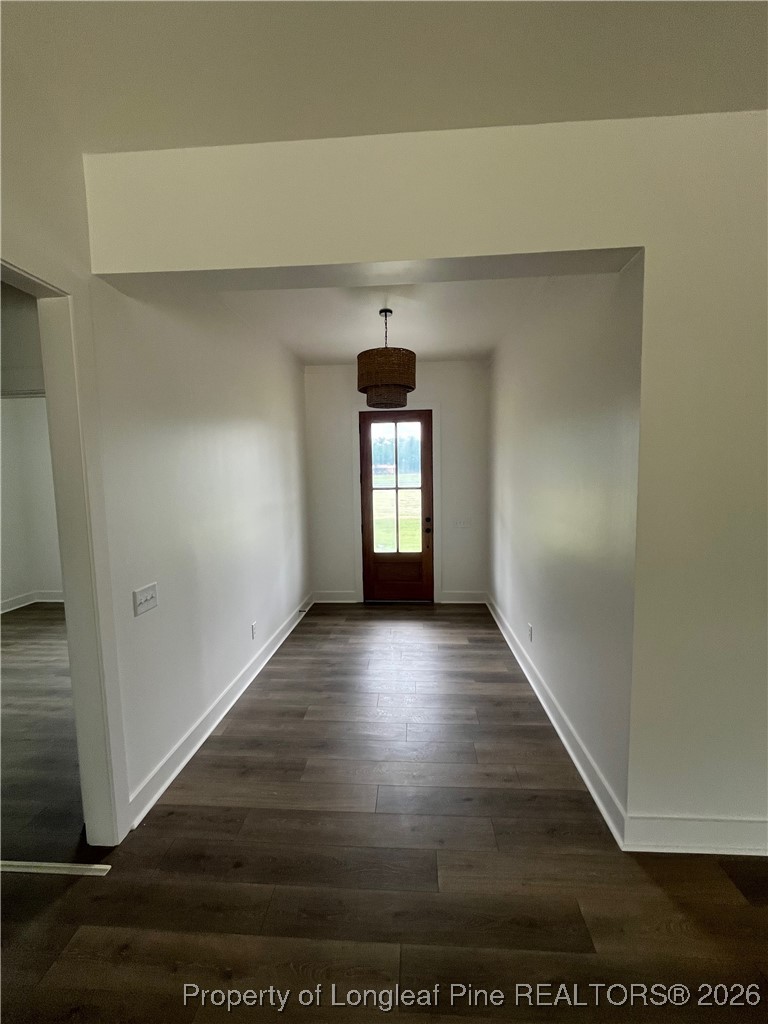 115 Keyser Street Aberdeen, NC 28315 - Photo 12 of 17 a view of empty room with window and wooden floor