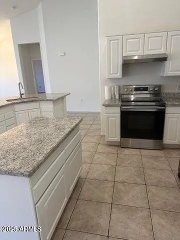 a kitchen with stainless steel appliances granite countertop a sink and cabinets