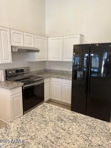 a kitchen with a refrigerator and cabinets