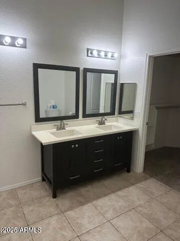 a bathroom with a double vanity sink and mirror