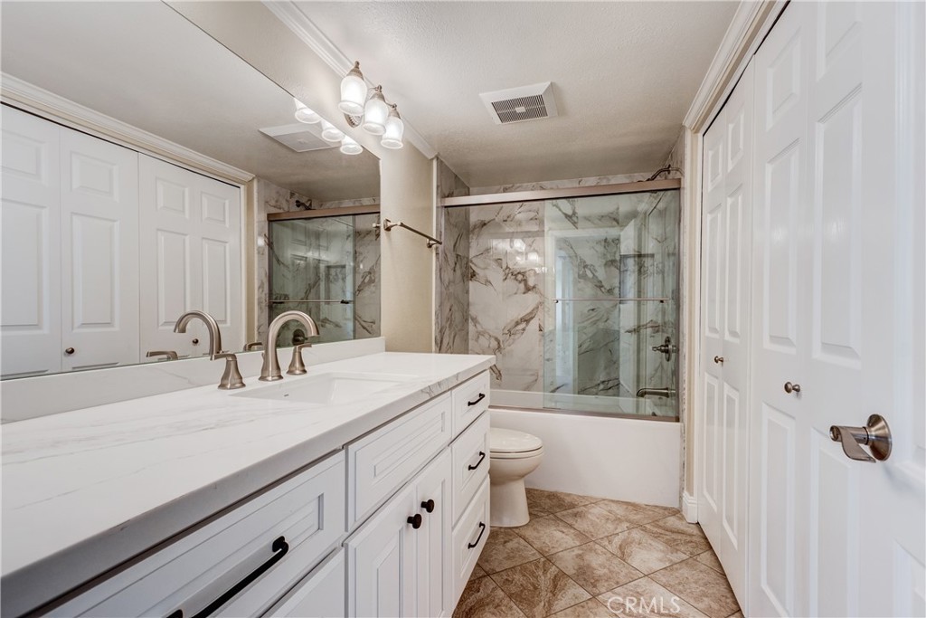 34004 Selva Road, Unit 384 Dana Point, CA 92629 - Photo 25 of 35 a bathroom with a double vanity sink toilet mirror and bathtub