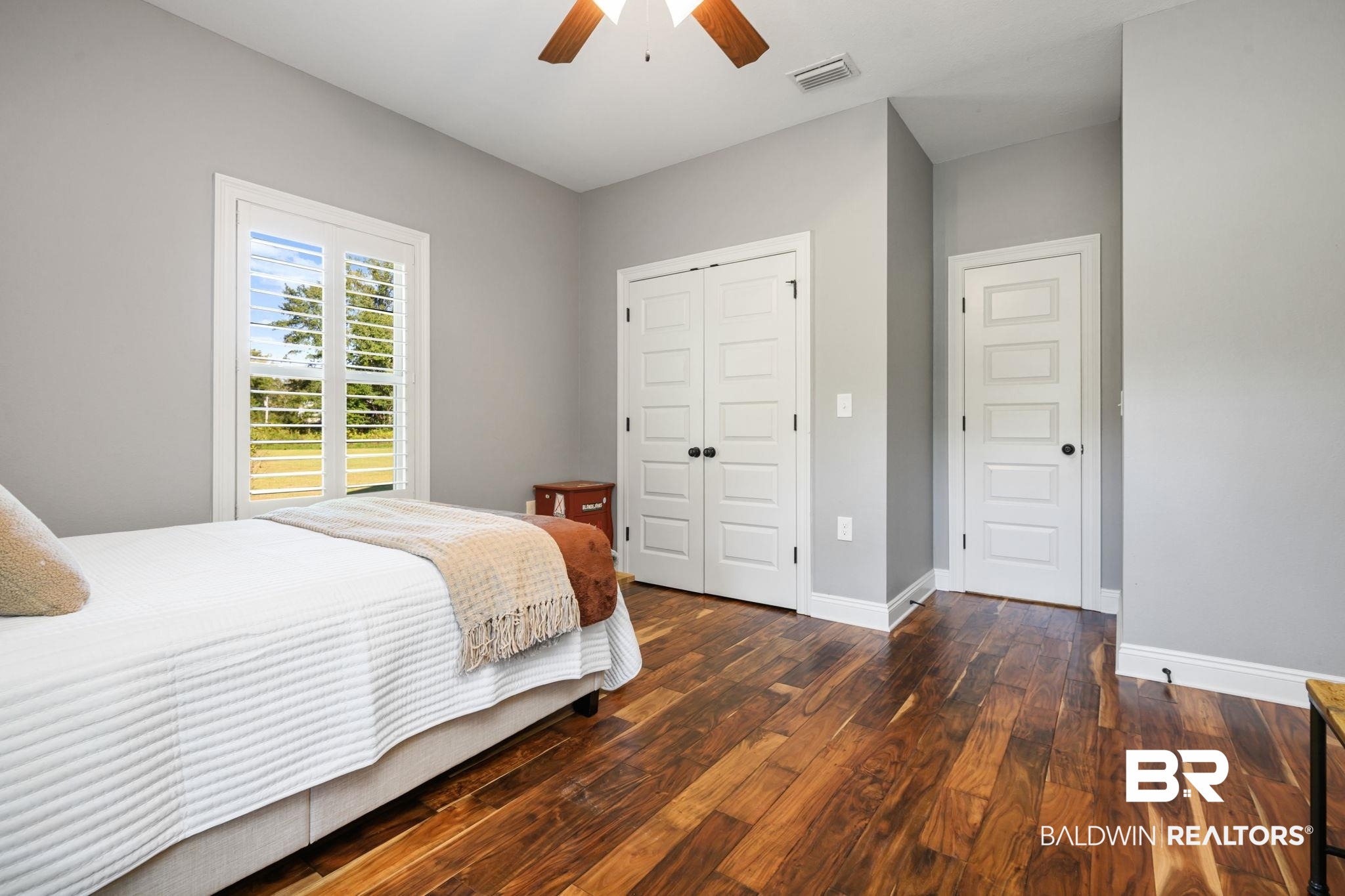 52579 Stockton Cemetery Road Stockton, AL 36507 - Photo 25 of 66 Bedroom with dark wood-type flooring, a closet, and a ceiling fan