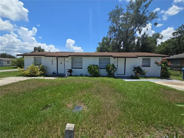 a front view of house with yard and green space