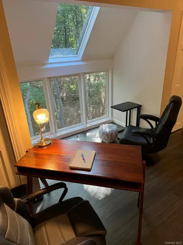 a view of a room with furniture and window