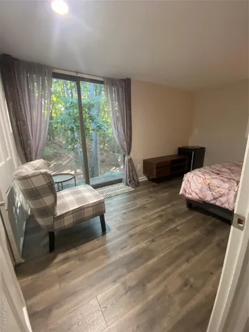 a bedroom with a bed and large window