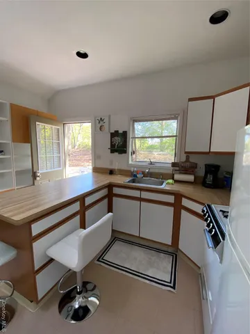 a kitchen with a sink appliances and a counter top space