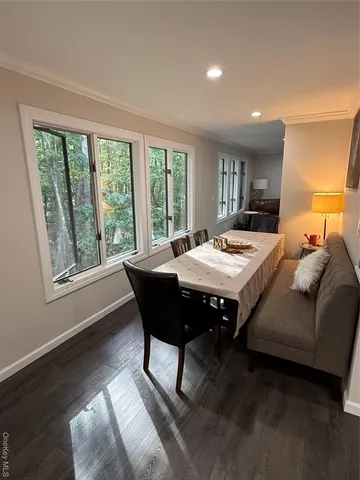 a living room with a table chairs and a table