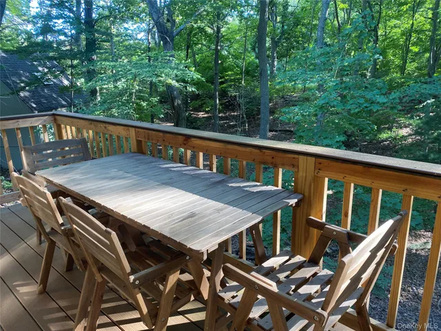 a view of a balcony with table and chairs