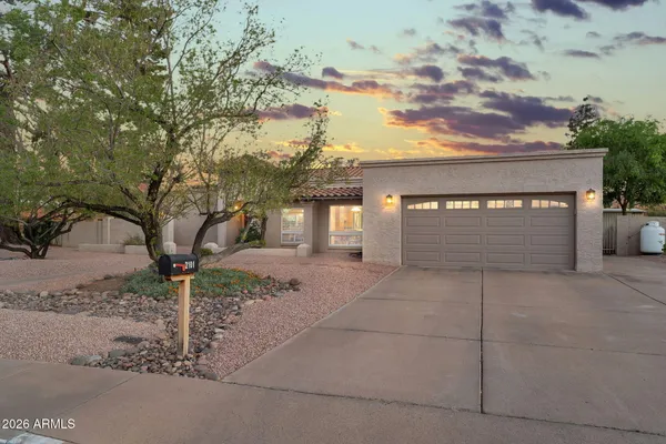 a front view of a house with a yard and shrubs