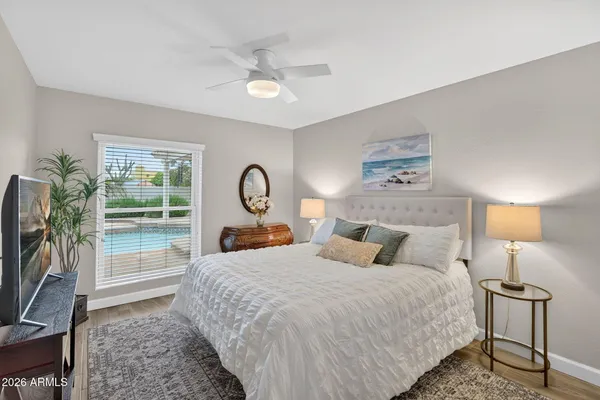 a patio with a table and chairs and a barbeque