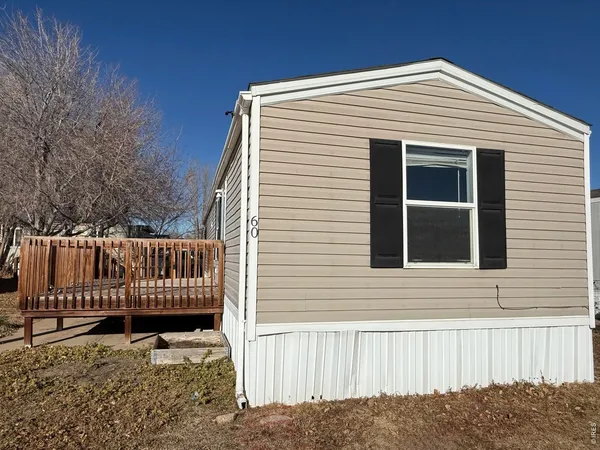a view of a house with wooden fence