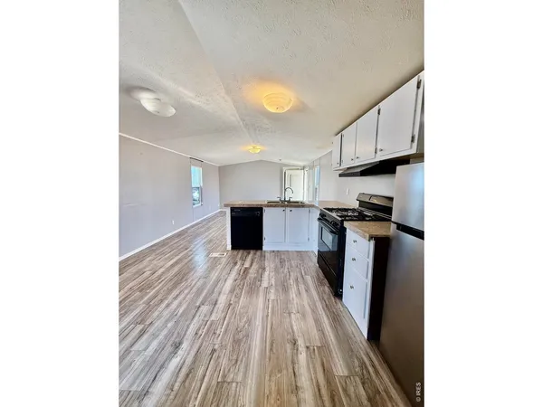 a kitchen with a refrigerator and a stove