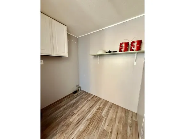 a view of a room with wooden floor