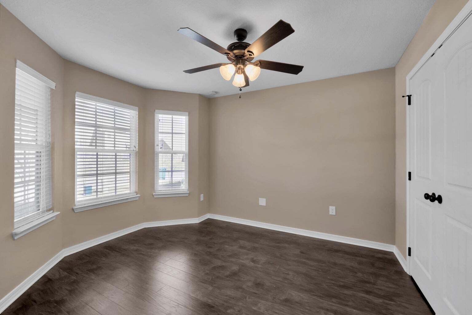 446 Eisenhower Drive Crestview, FL 32539 - Photo 11 of 25 wooden floor in an empty room with a window
