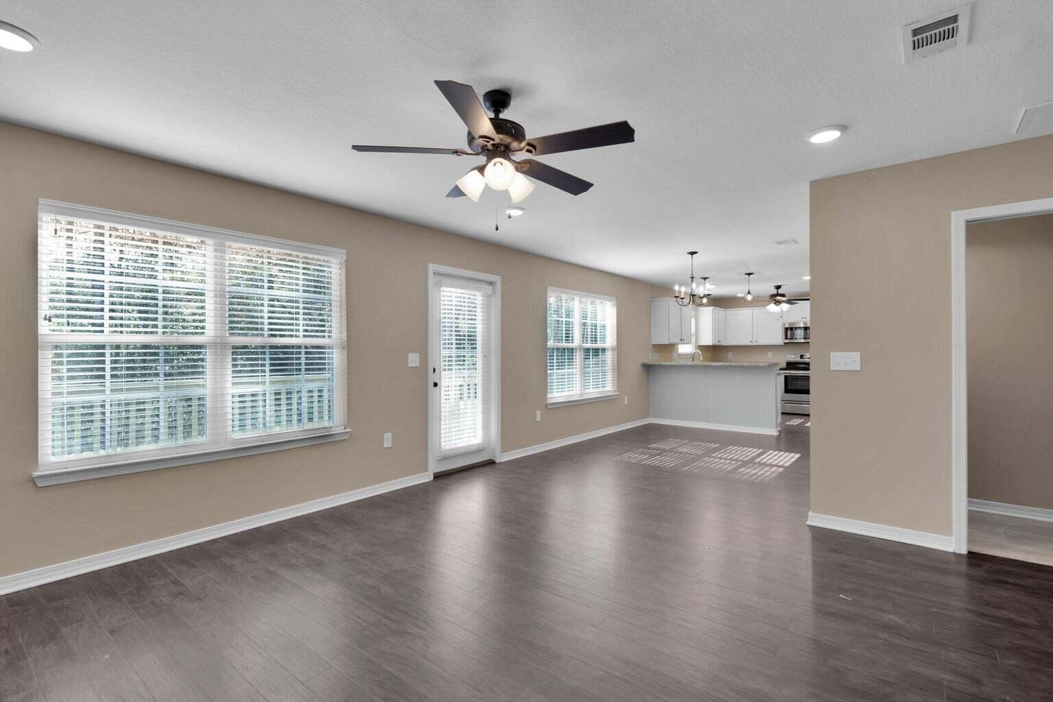 446 Eisenhower Drive Crestview, FL 32539 - Photo 13 of 25 a view of an empty room with a window and wooden floor