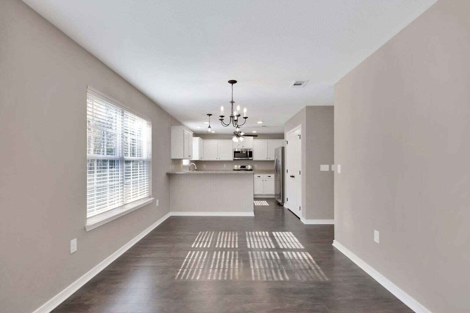 446 Eisenhower Drive Crestview, FL 32539 - Photo 3 of 25 a view of a kitchen with granite countertop stainless steel appliances a window and a counter space