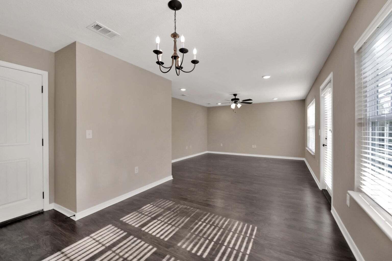 446 Eisenhower Drive Crestview, FL 32539 - Photo 10 of 25 wooden floor in an empty room with a window