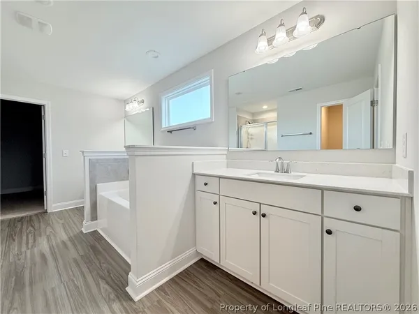 a spacious bathroom with a double vanity sink and mirror