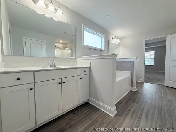 a kitchen with cabinets and wooden floor