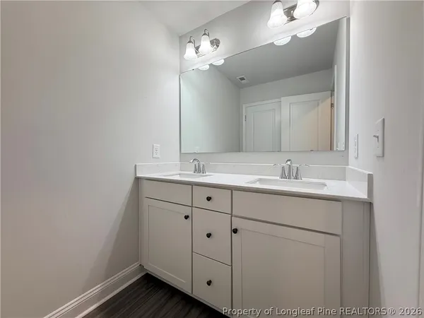 a bathroom with a sink vanity and mirror