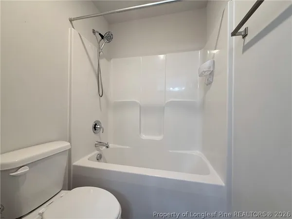 a bathroom with a toilet and a bathtub
