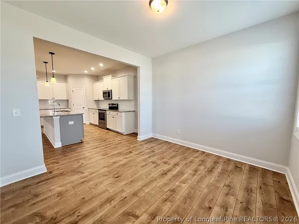 a view of a kitchen with a stove cabinets and wooden floor