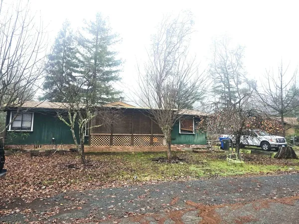 a backyard of a house with barbeque oven table and chairs