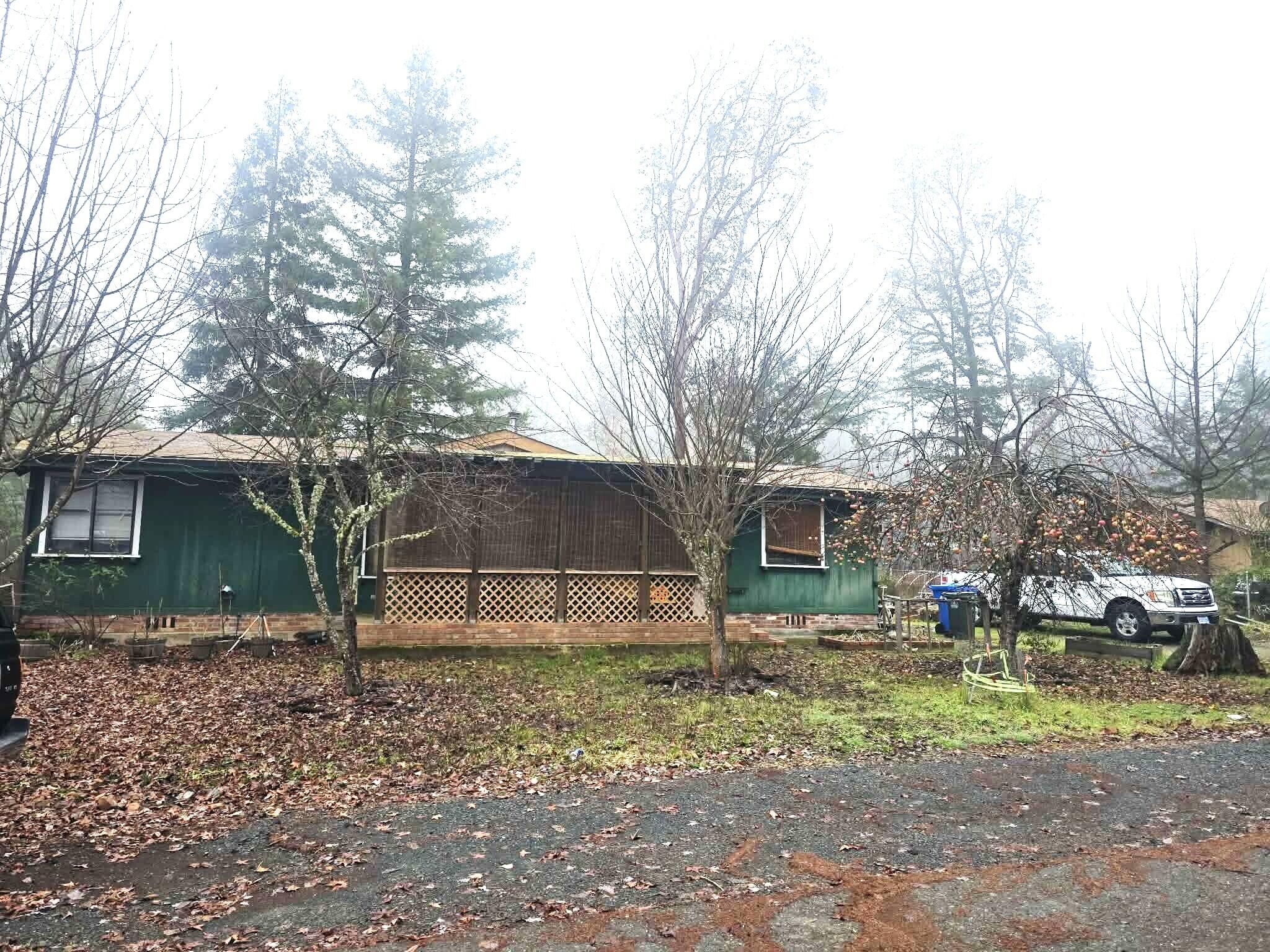 a backyard of a house with barbeque oven table and chairs